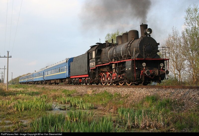 Steam train with blue passenger cars