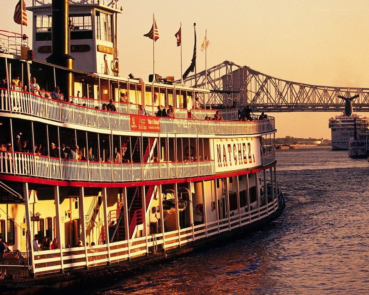 Steamboat on a river at sunset