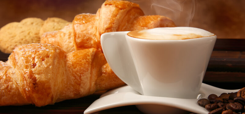 Steaming Cappuccino and Croissants
