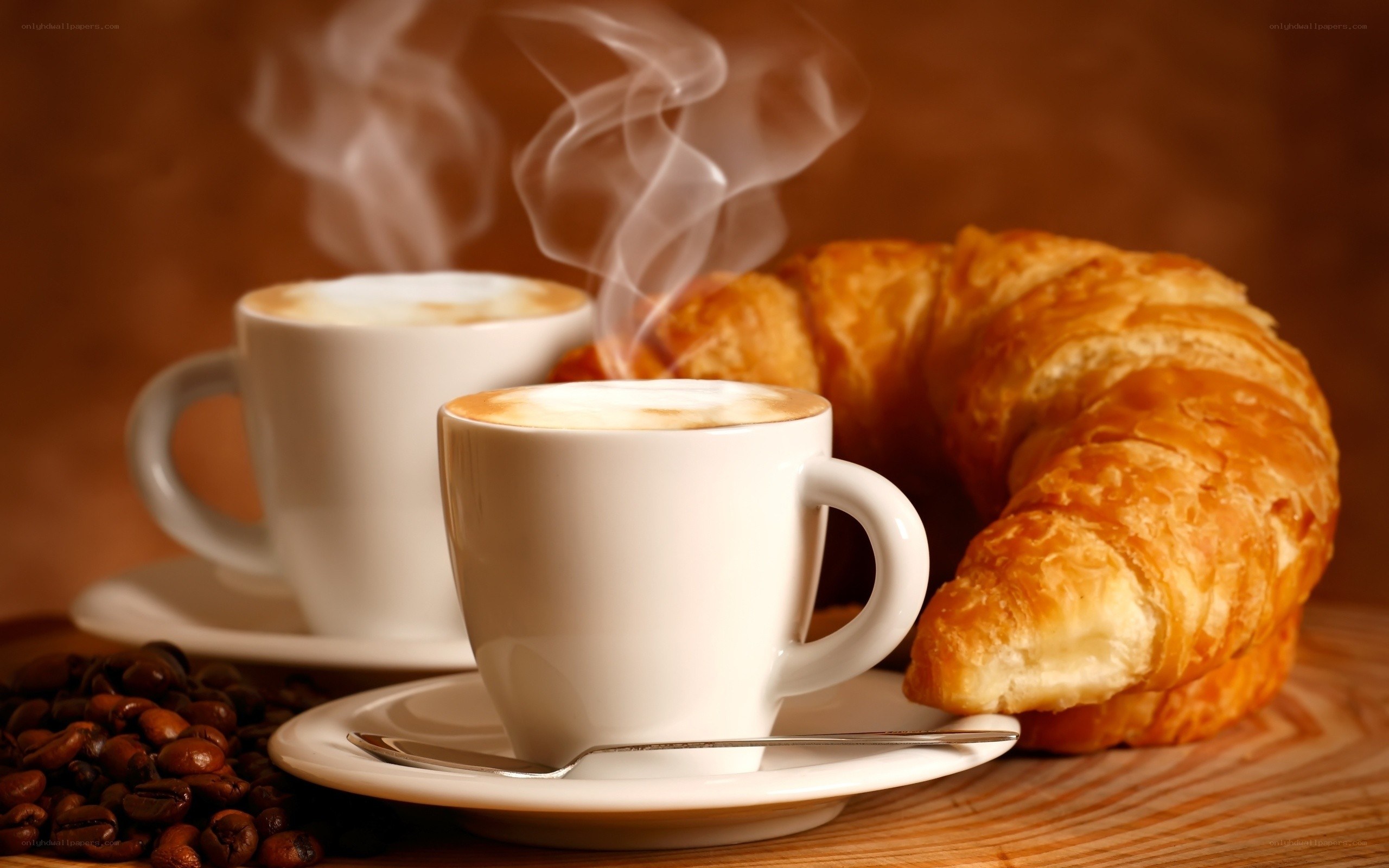 Steaming coffee and croissants
