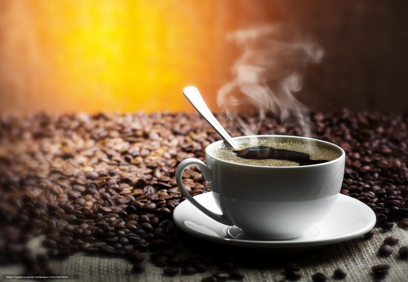 steaming coffee cup on beans