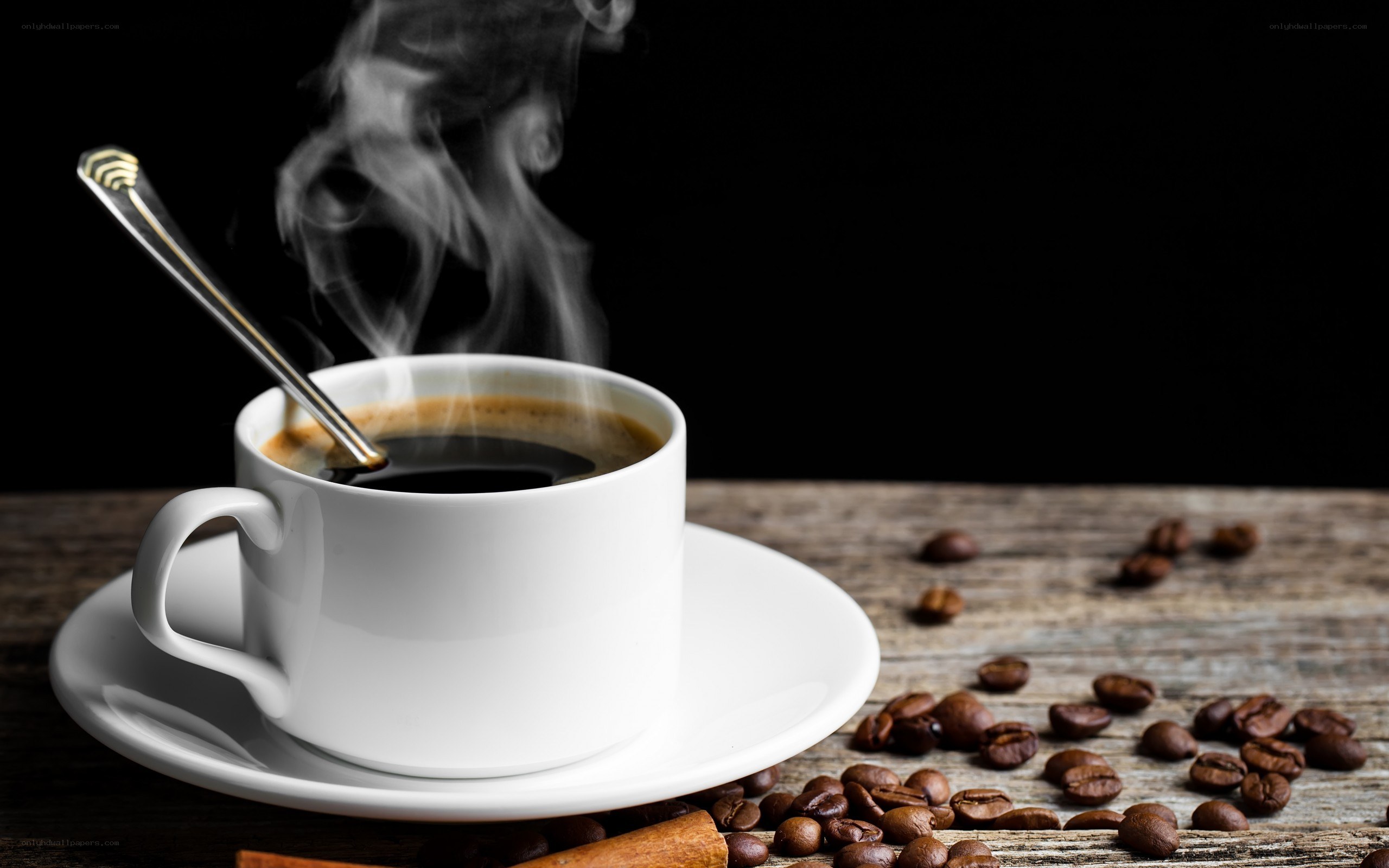steaming coffee cup on wood