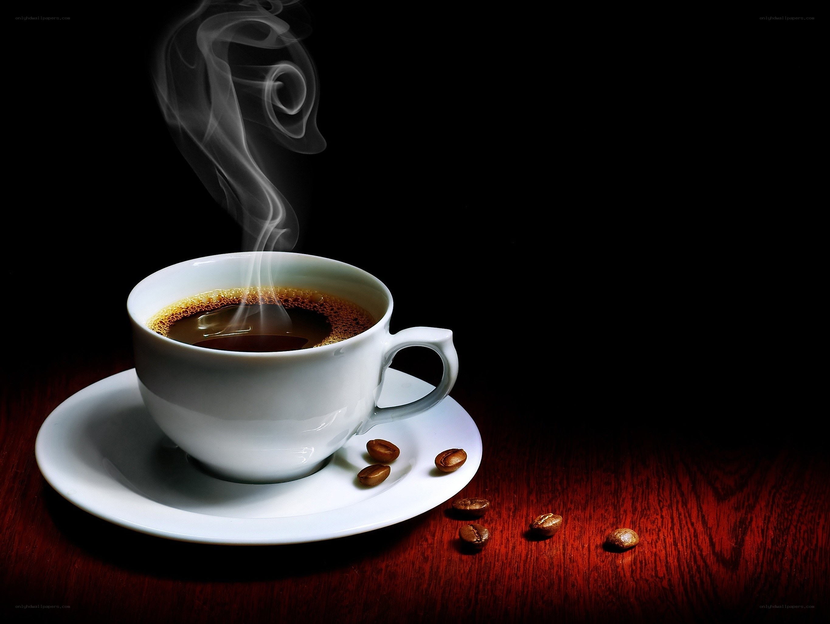 Steaming coffee cup on wood