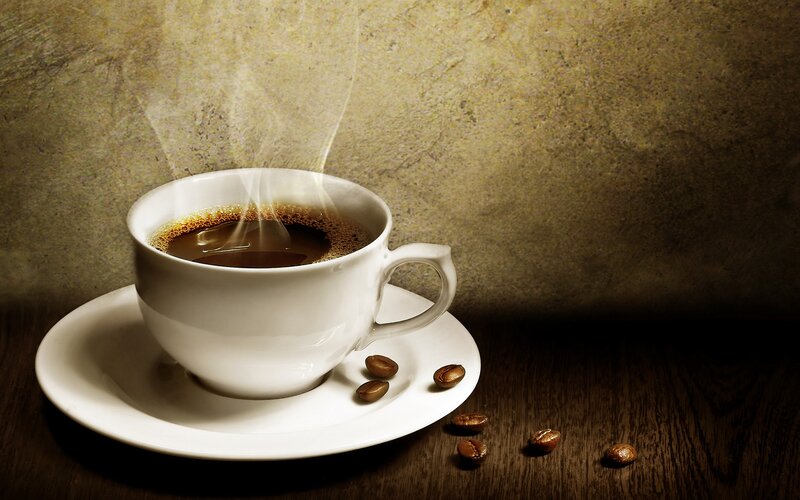 steaming coffee cup on wood