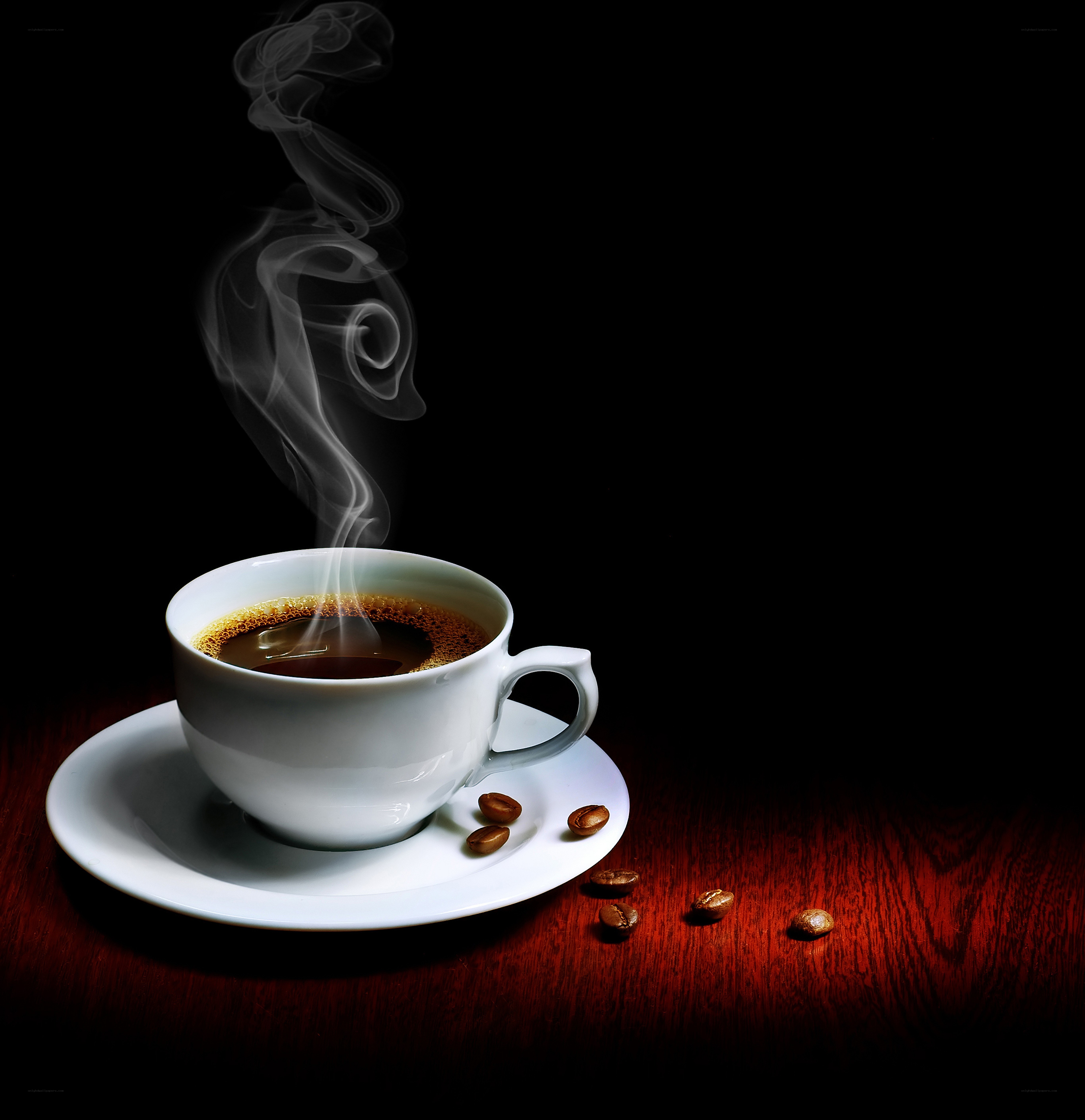 steaming coffee cup on wood