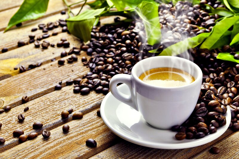 steaming coffee cup with beans
