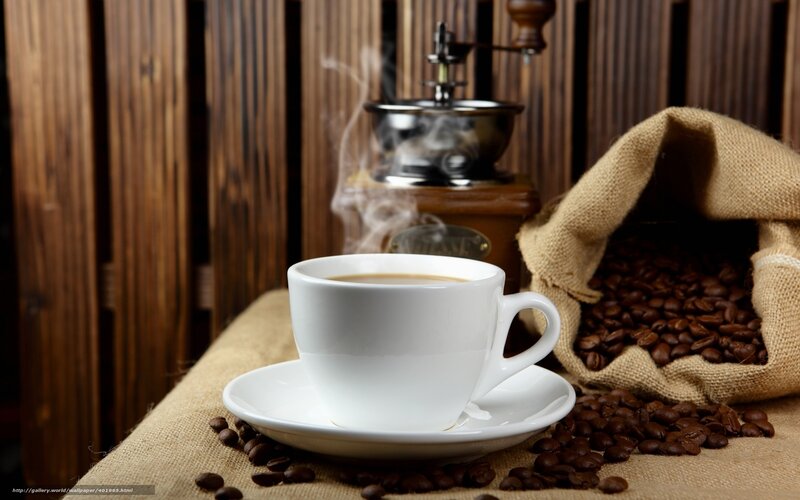 steaming coffee cup with beans