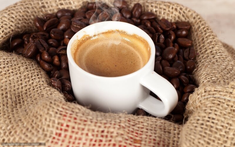 steaming coffee cup with beans