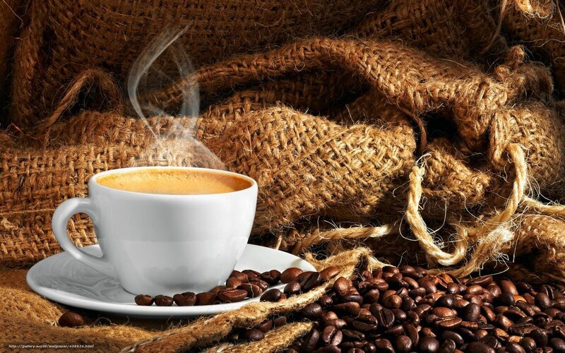 steaming coffee cup with beans