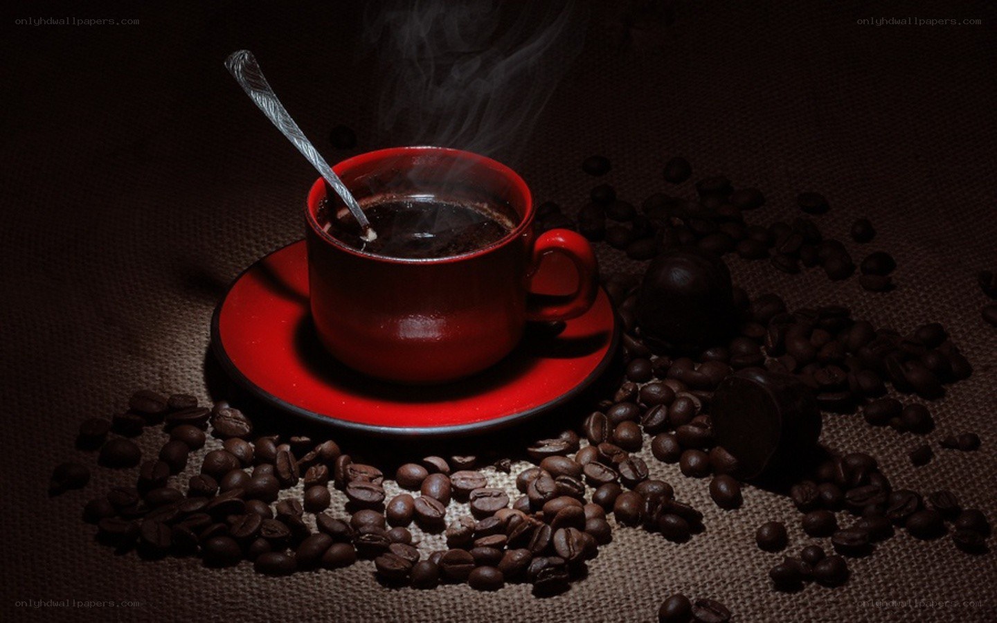 steaming coffee cup with beans