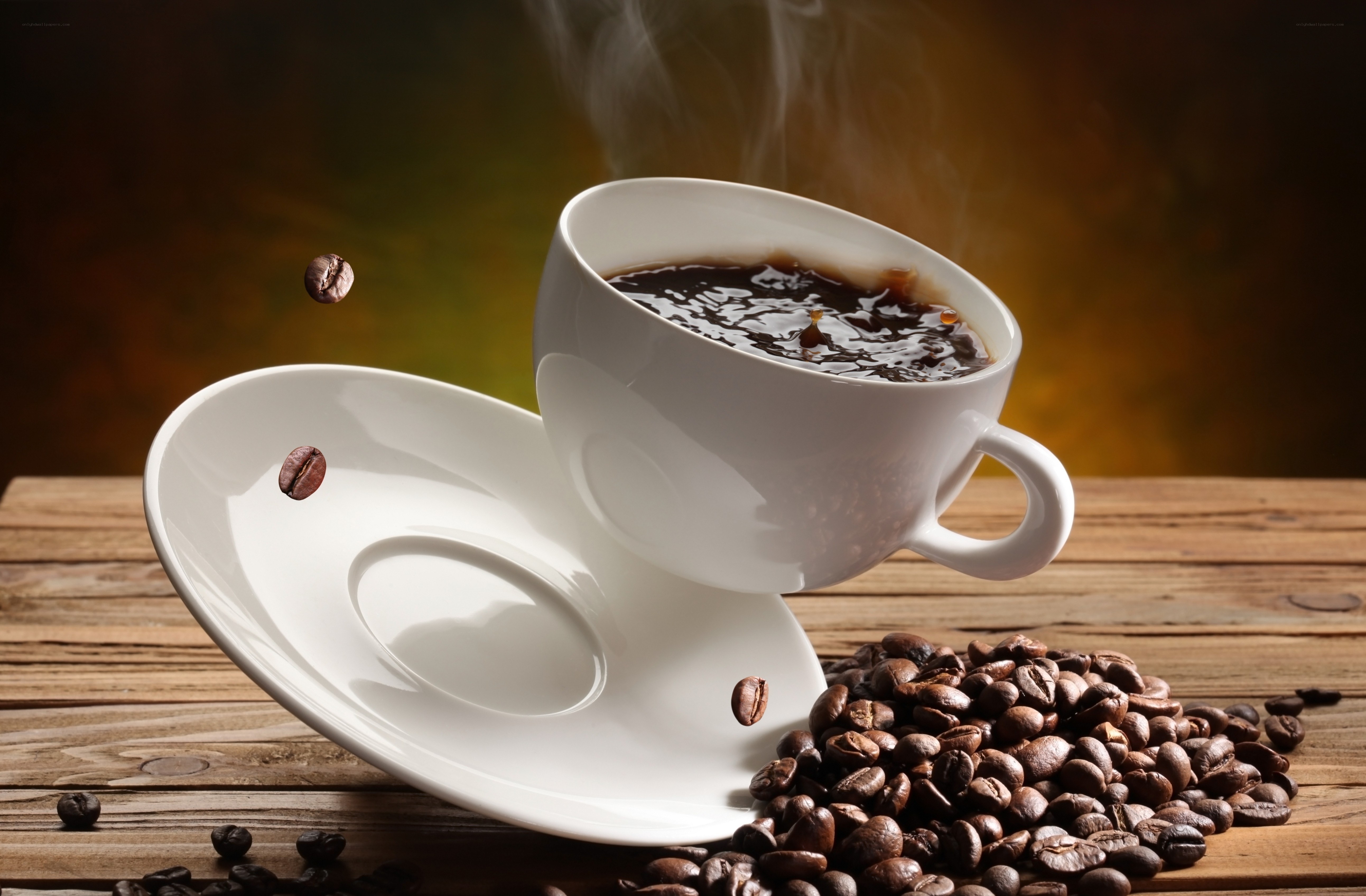 steaming coffee cup with beans