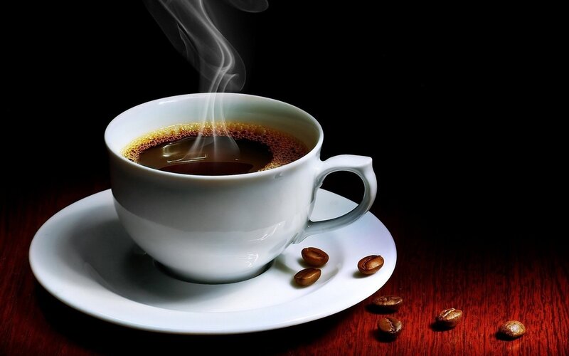 Steaming Coffee Cup — Wooden Table