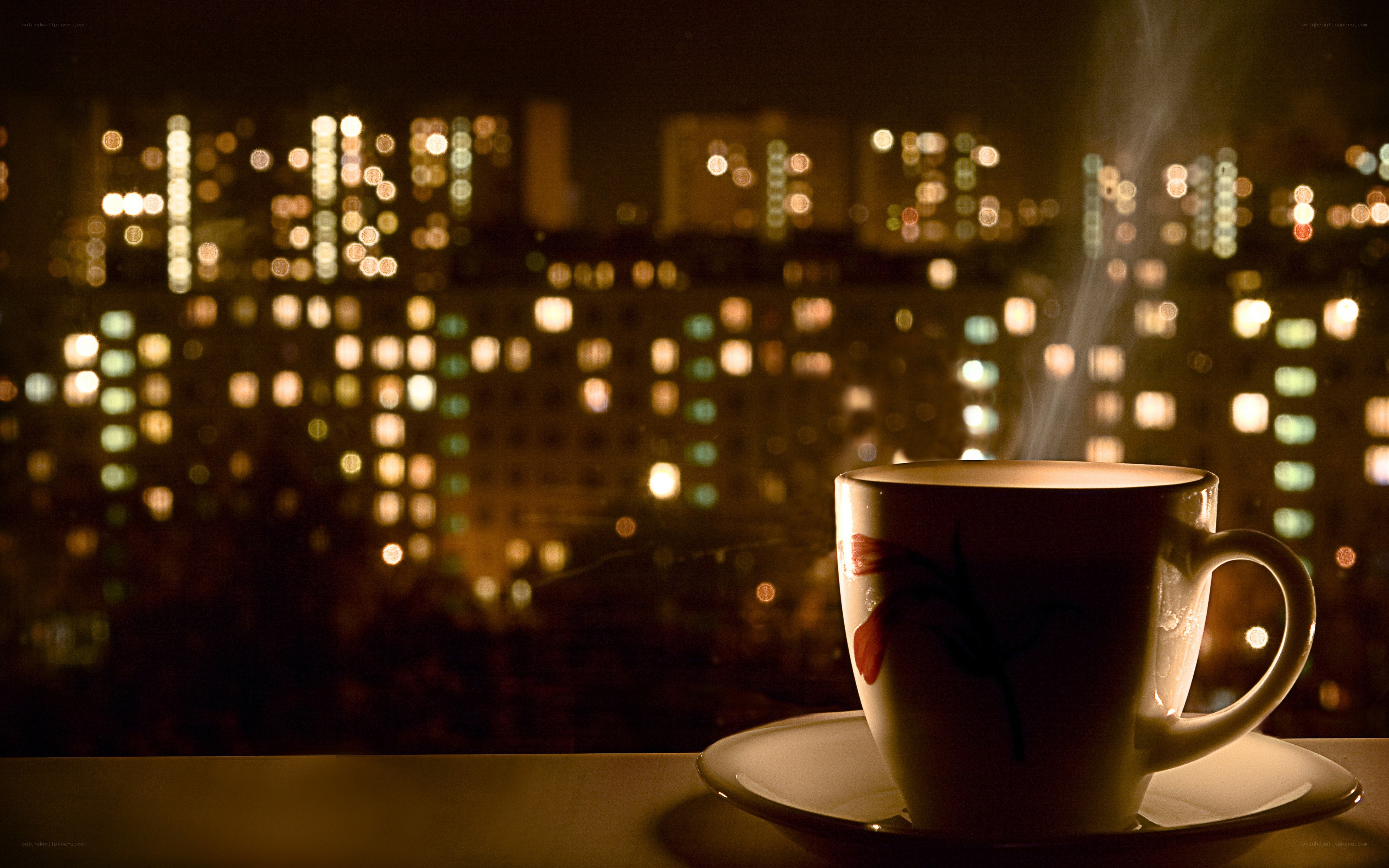 steaming coffee with city lights