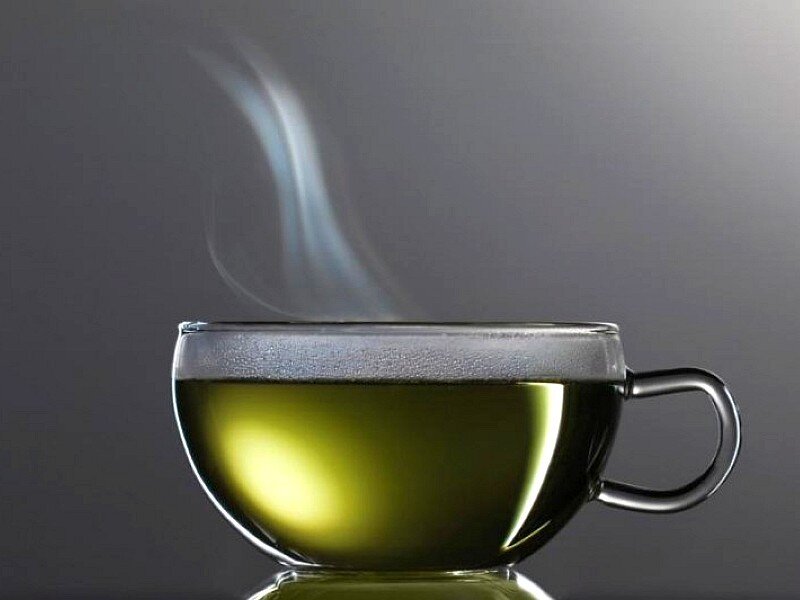 steaming green tea cup