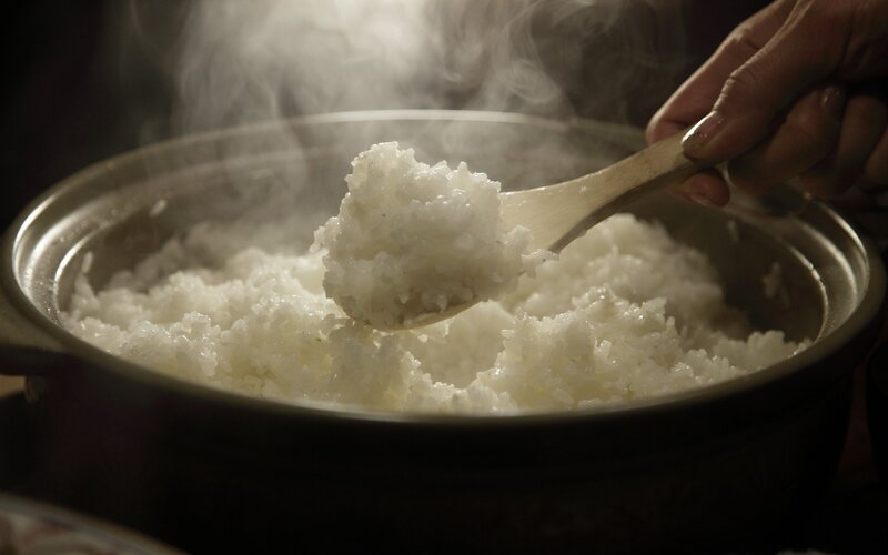 steaming rice in a pot