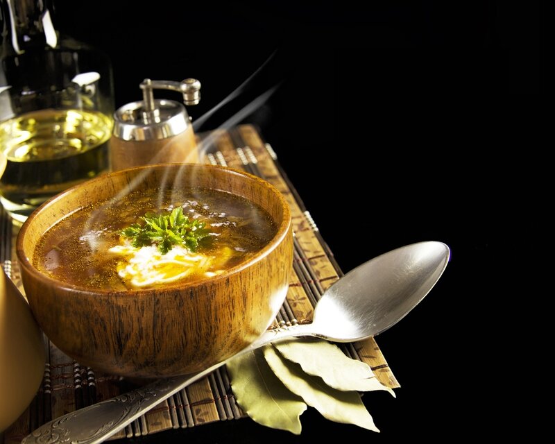 Steaming soup in wooden bowl