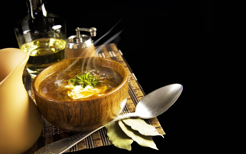 Steaming soup with herbs