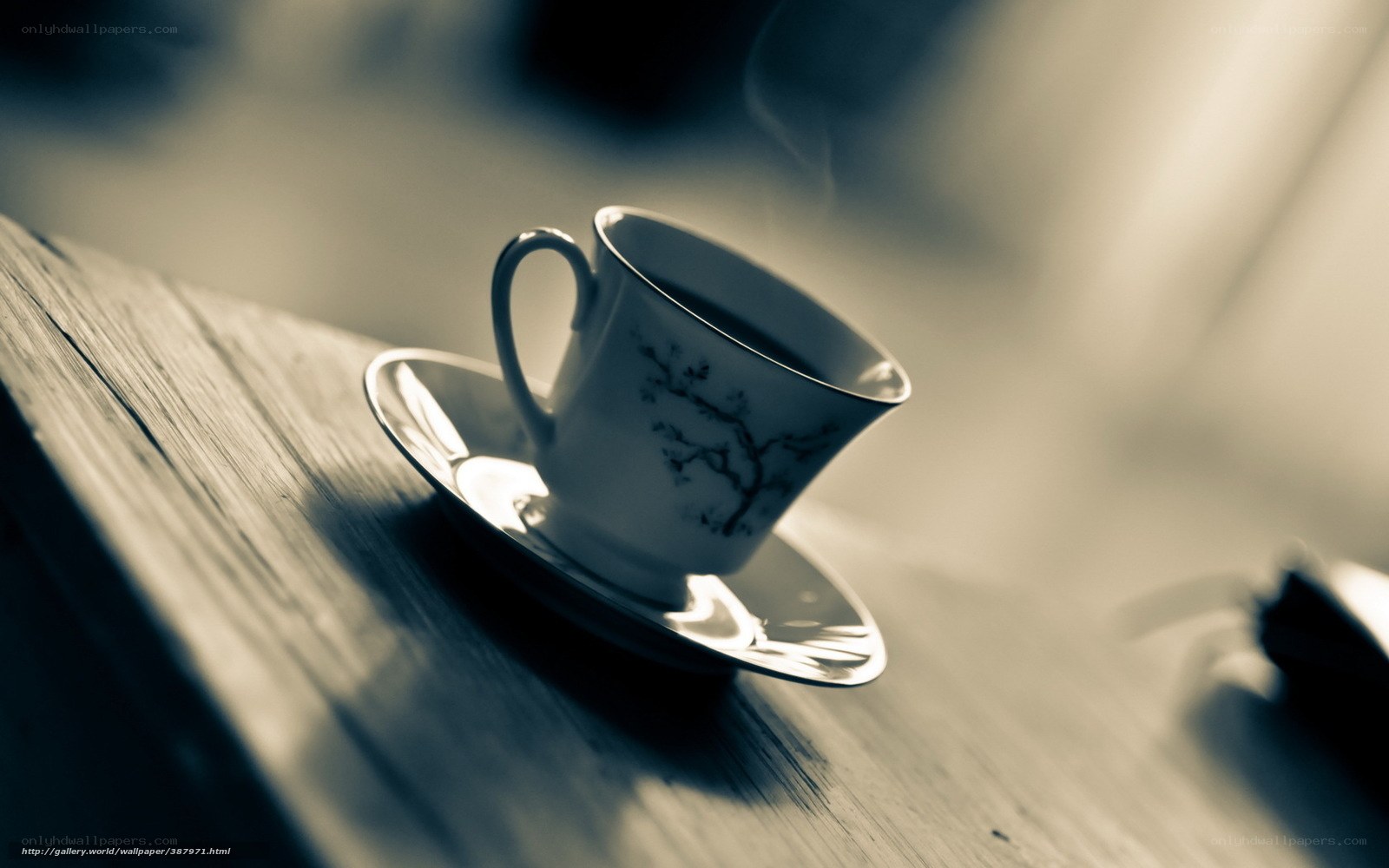 steaming tea cup on wood