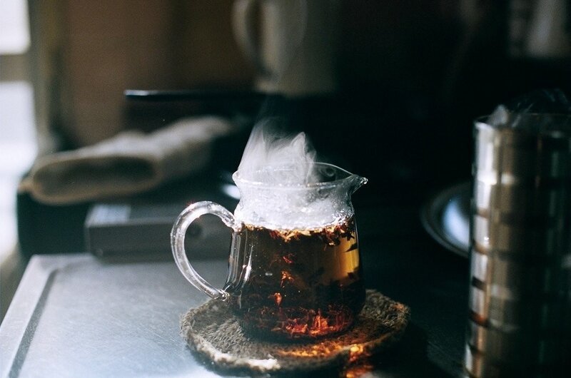 steaming tea in a glass pitcher