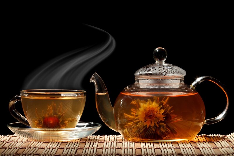 Steaming tea with blooming flower