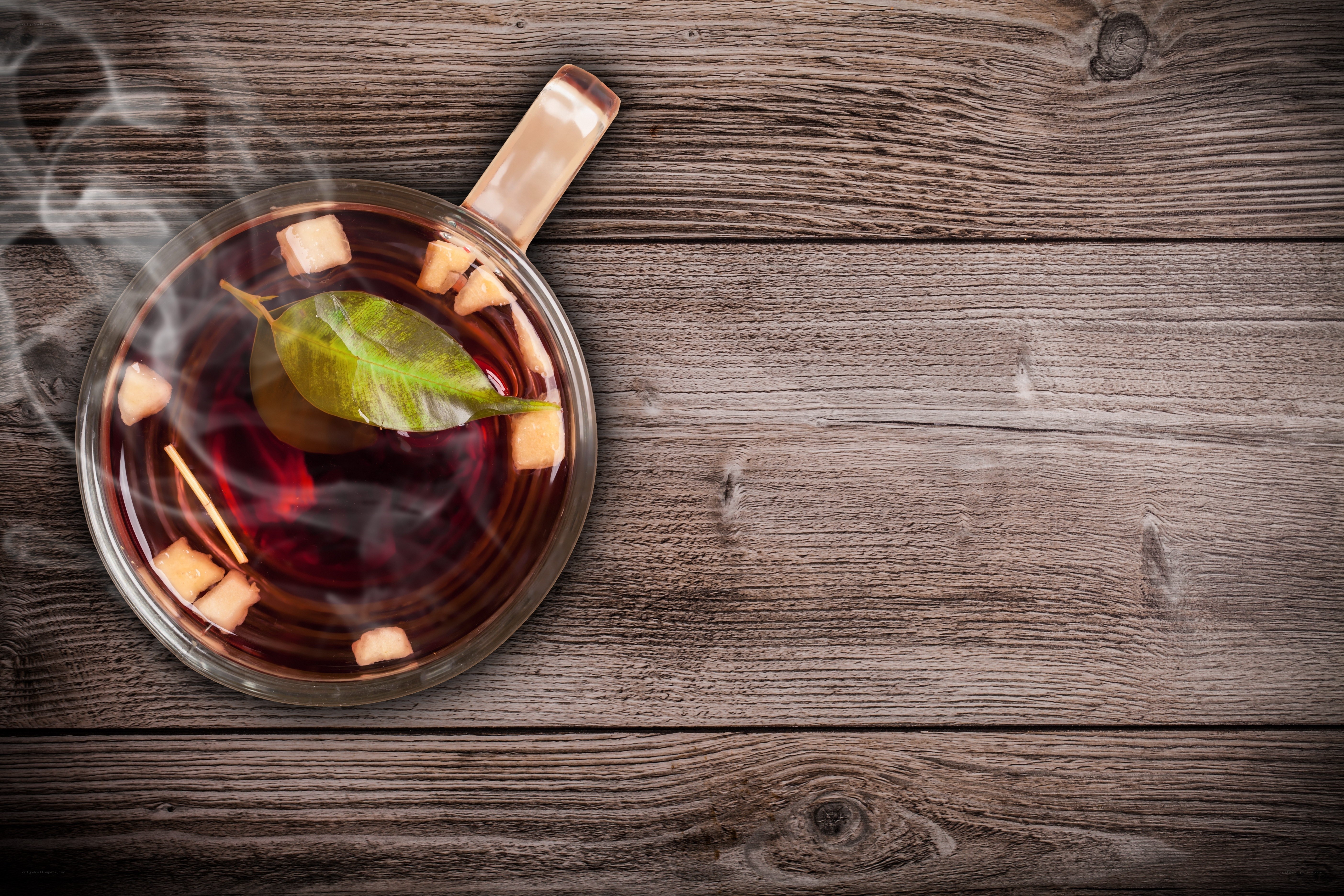 steaming tea with leaf and sugar