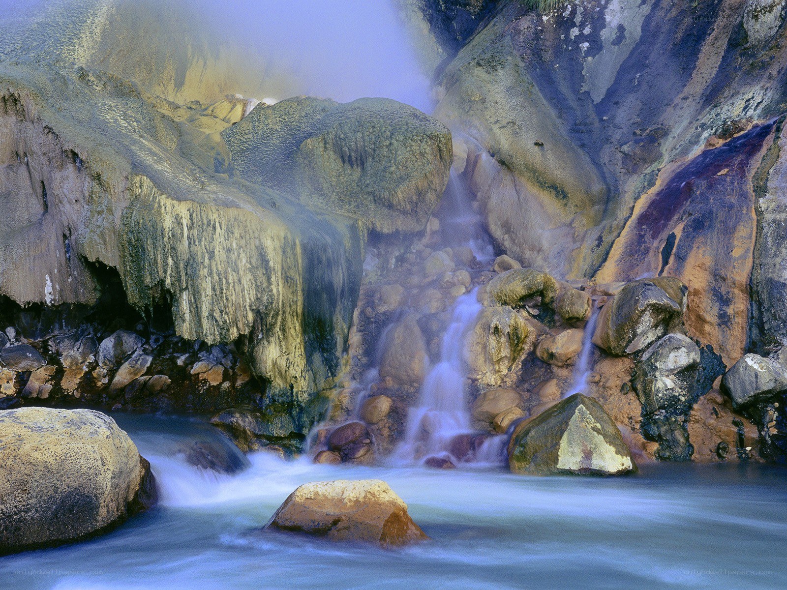 Steamy waterfall in rocky canyon