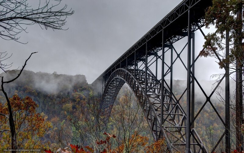 Steel arch bridge in autumn mist