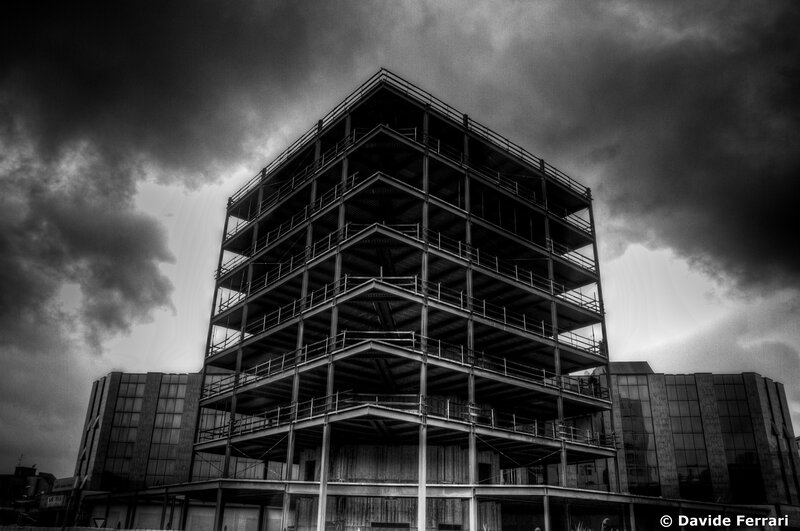 Steel frame building under stormy sky