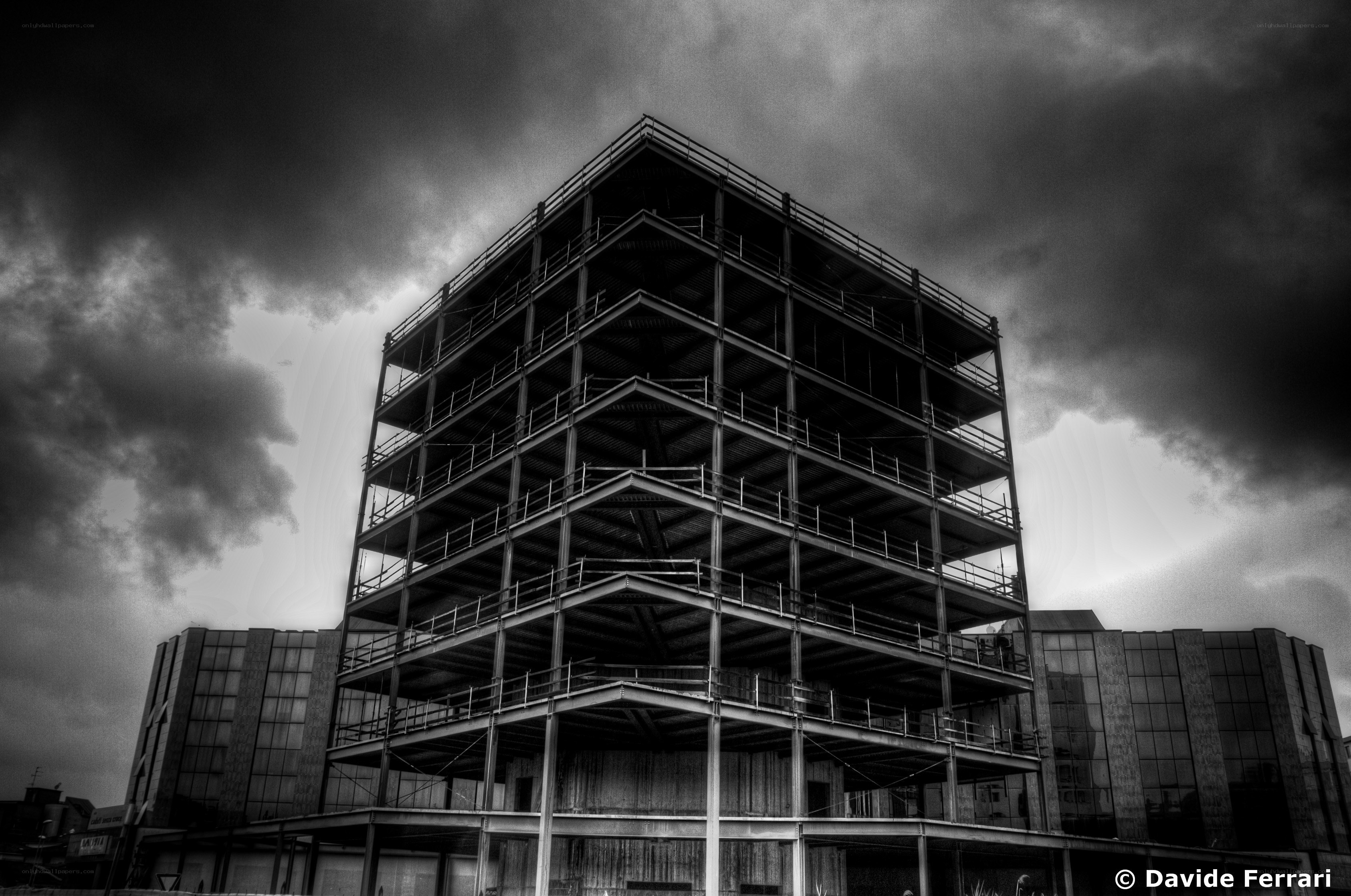 Steel frame building under stormy sky