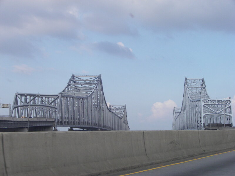 steel truss bridge under cloudy sky