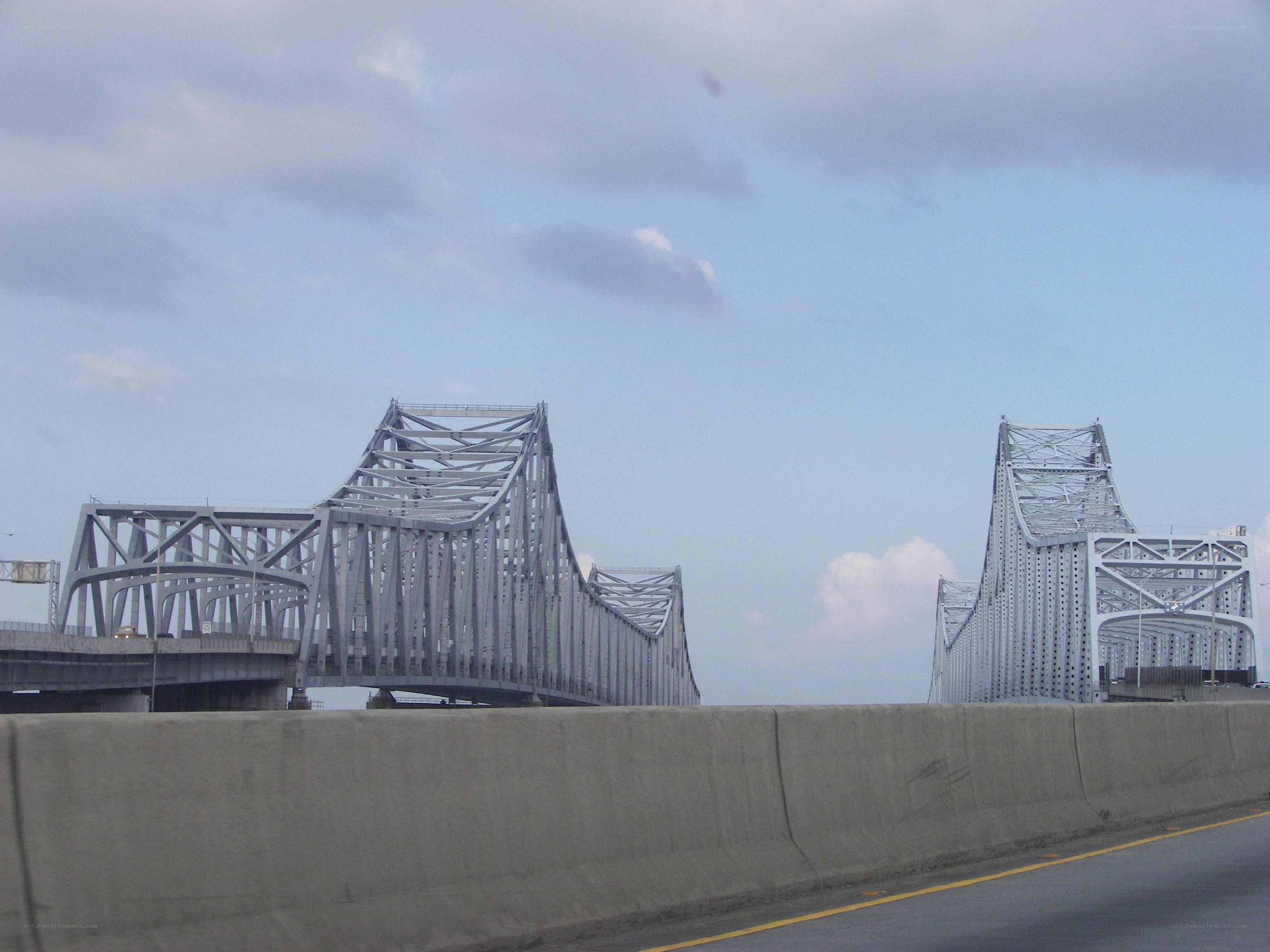 steel truss bridge under cloudy sky