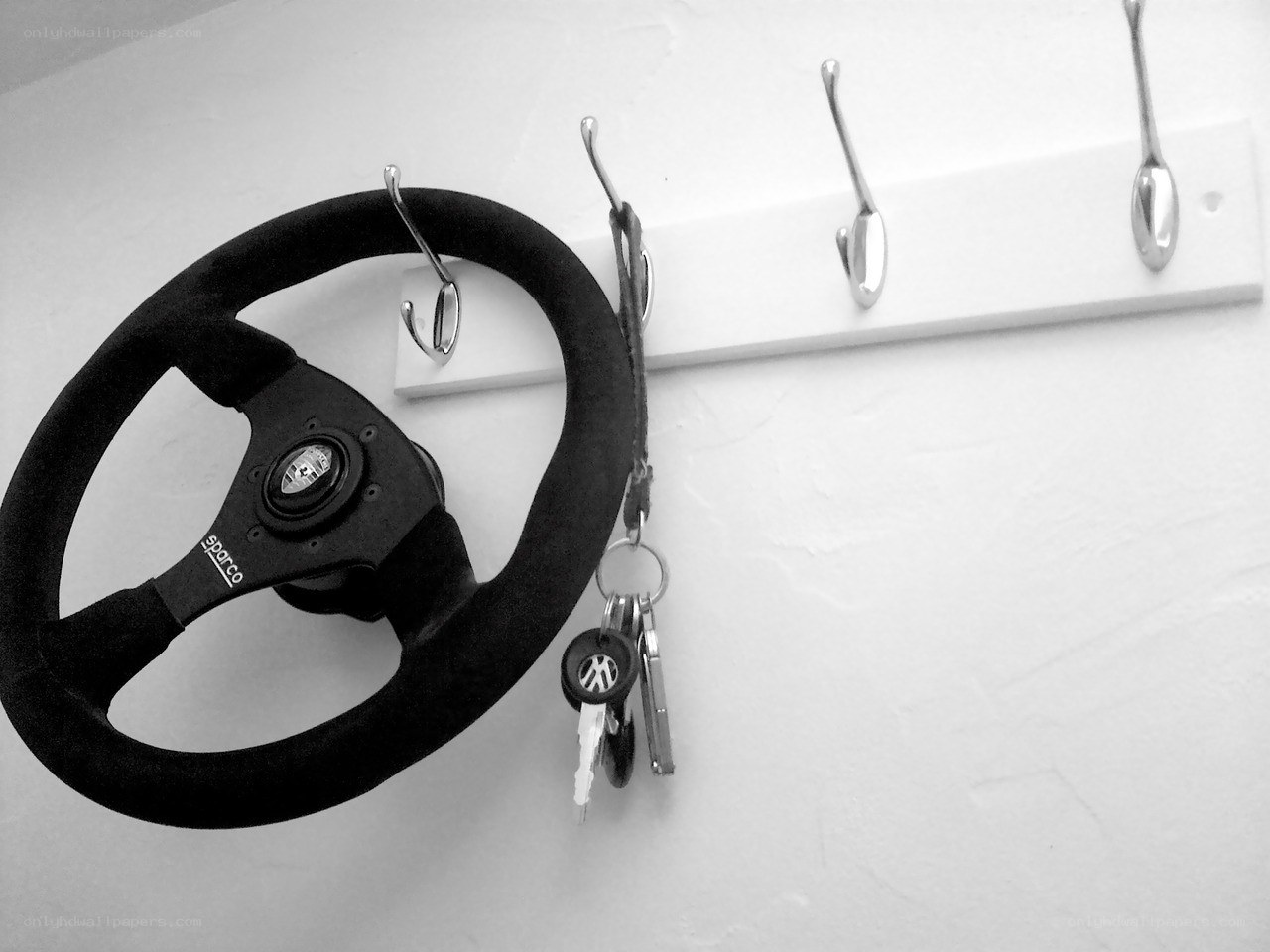 steering wheel and keys on wall