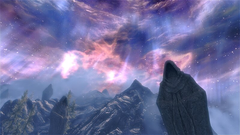 Stellar sky over mountain statues