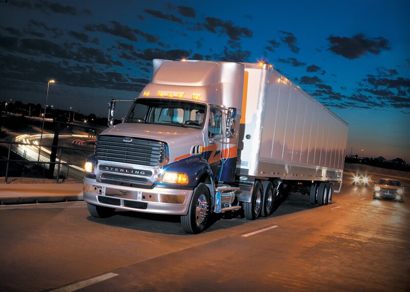 Sterling truck on highway at dusk