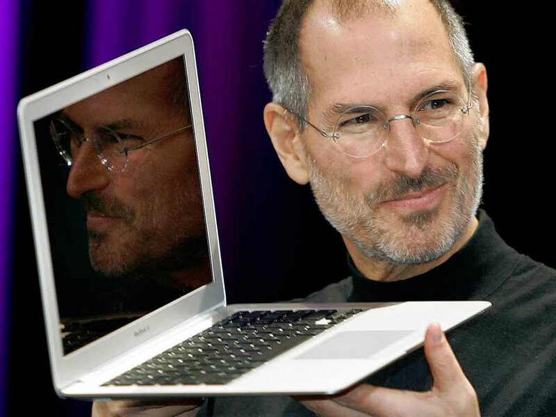 Steve Jobs Holding Laptop — White