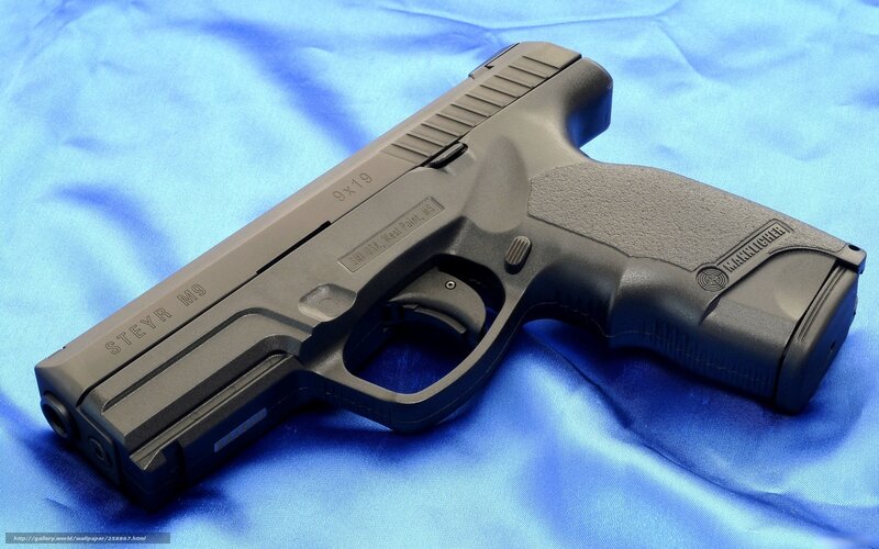 Steyr M9 pistol on blue cloth