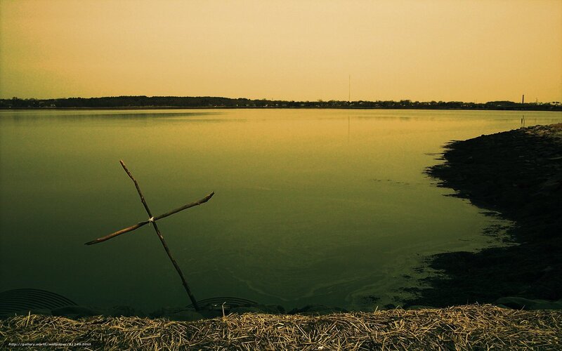 Stick cross by the water