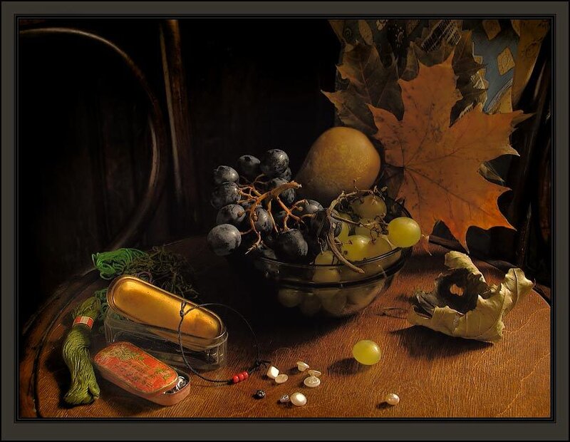 Still life with grapes and autumn leaves
