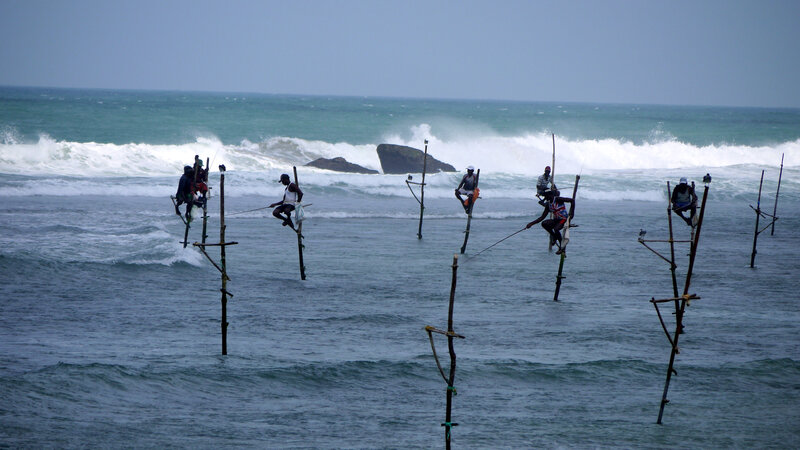 Stilt Fishermen in Ocean — Blue