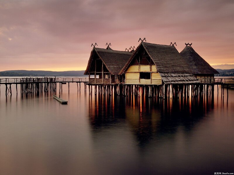 Stilt houses on a lake at sunset