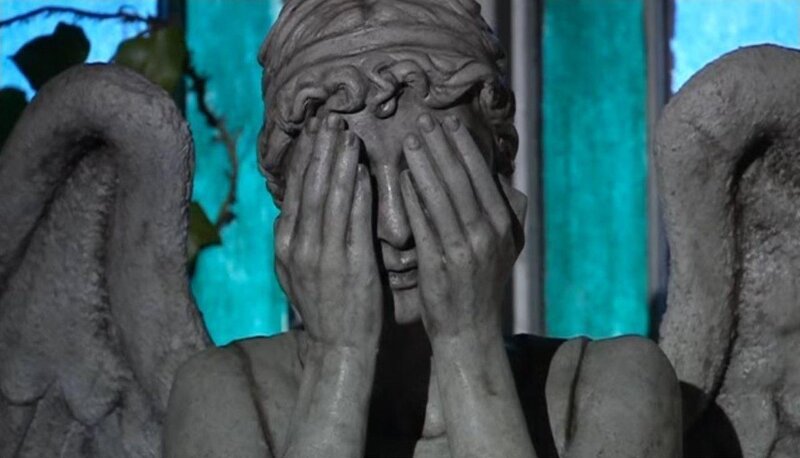 stone angel statue covering face