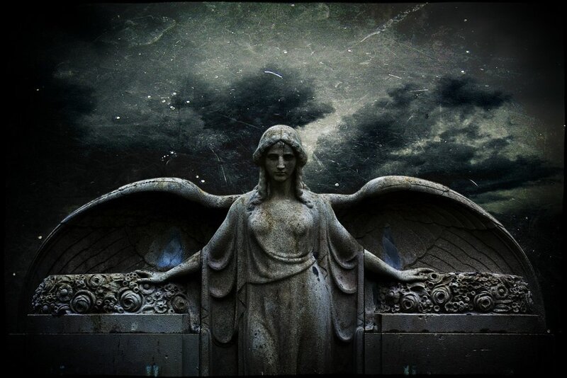 stone angel statue in dark setting
