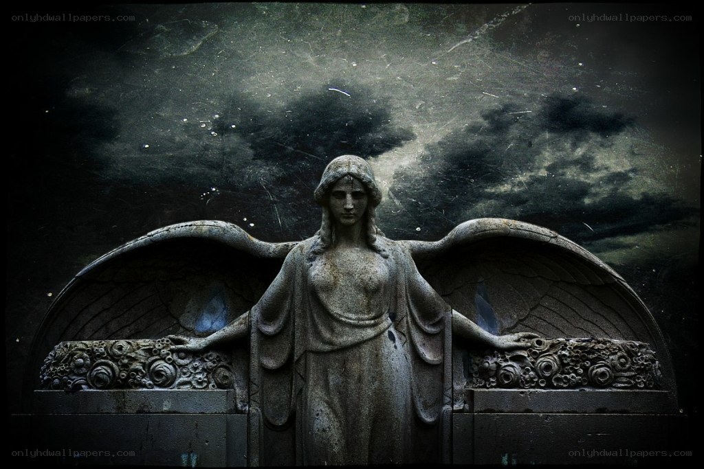 stone angel statue in dark setting