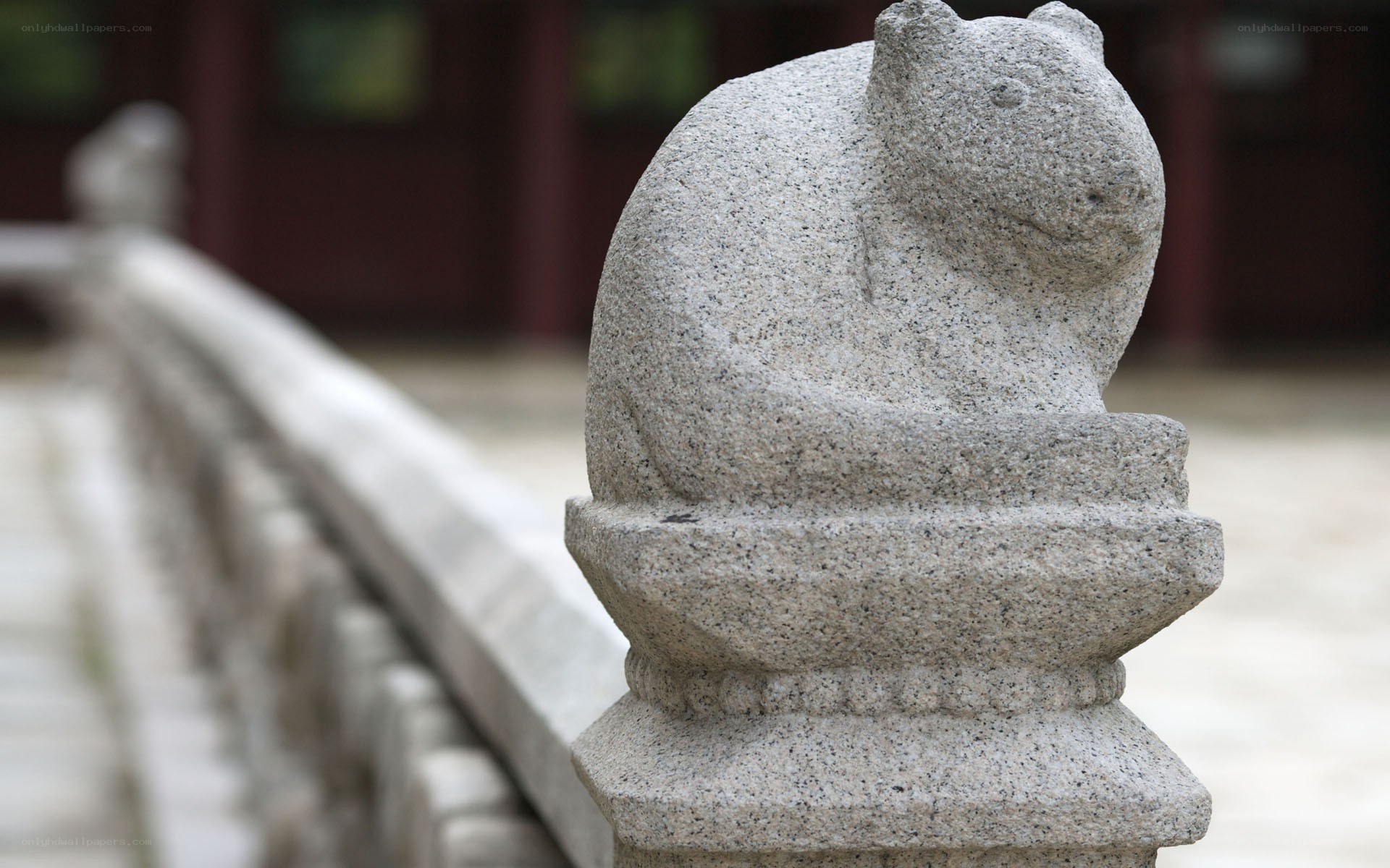 stone animal sculpture on railing