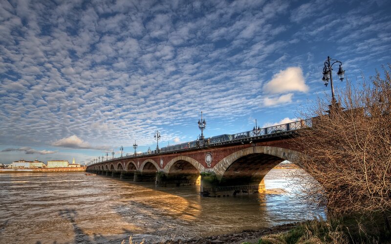 Stone Arch Bridge — Blue, Dramatic, Afternoon, Photograph, River, Clouds, Street Lamps