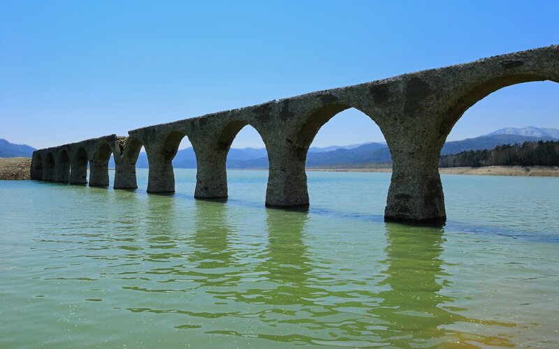 Stone Arch Bridge — Blue, Serene, Afternoon, Photograph, Lake, Mountains, Sky
