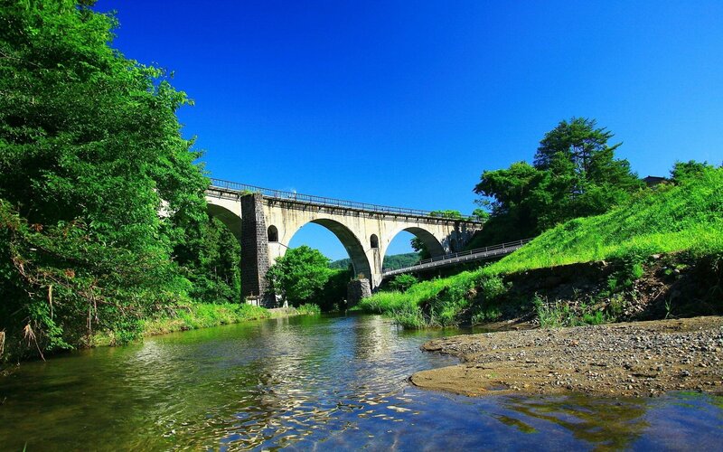 Stone Arch Bridge — Blue, Serene, Afternoon, Photograph, River, Trees, Sky, Green