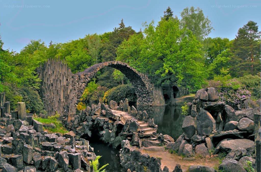 Stone arch bridge in a lush garden