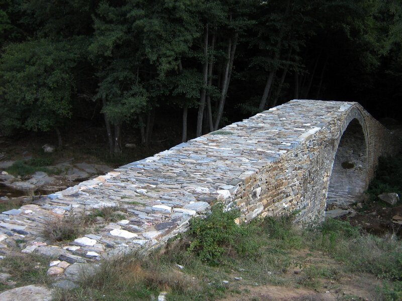 Stone arch bridge in forest