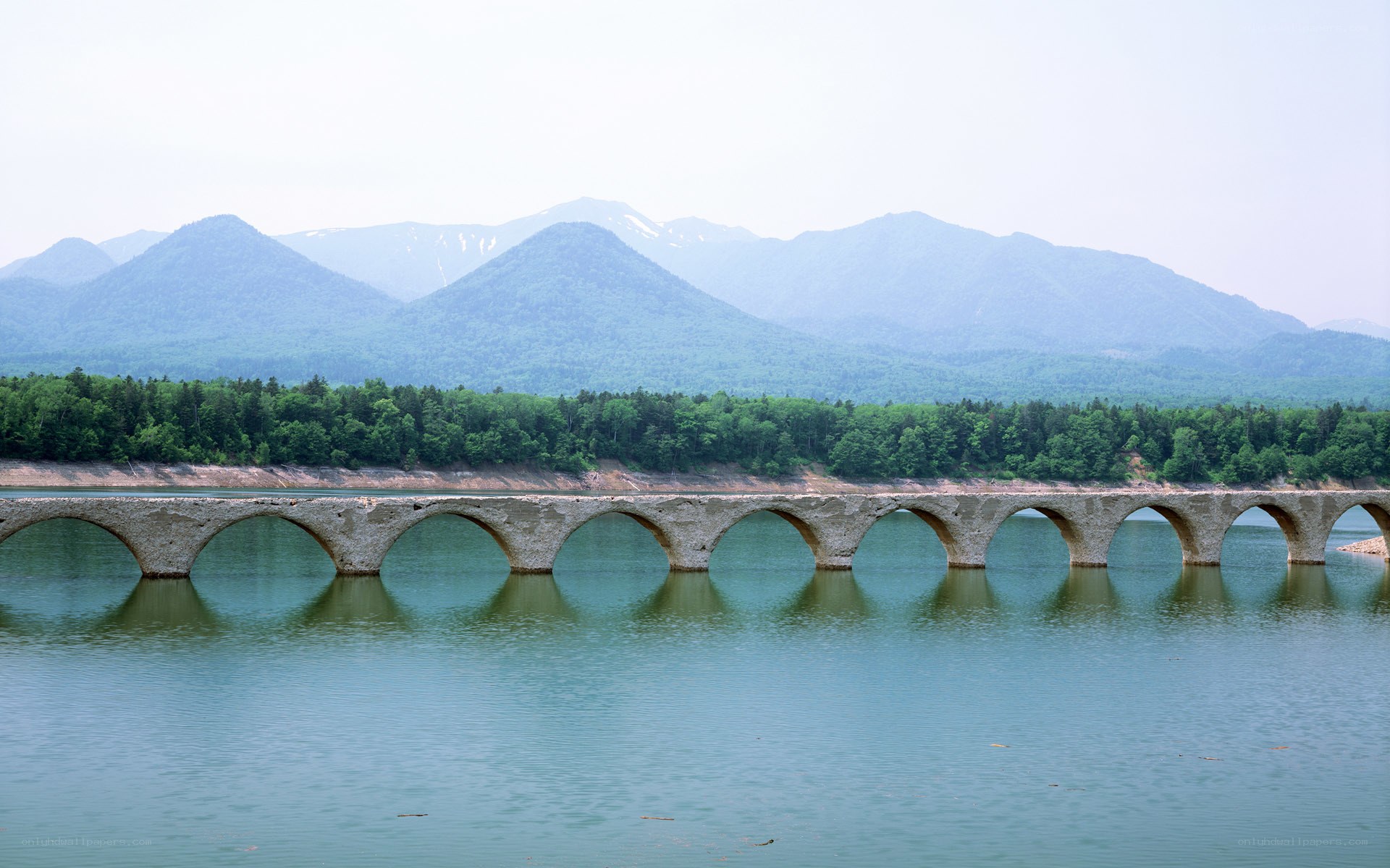 Stone arch bridge over lake